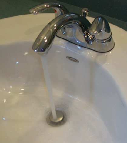 Illustrative photograph of a bathroom faucet. Not this business's work. Tomwsulcer, CC0, Wikimedia Commons.
